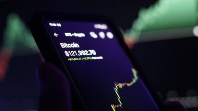 Inside The Prediction Markets: Draftkings Bets On The Cftc Model A20Phone20With20Bitcoin20Chart Id C45F8D25 5864 4Cd5 9Aa8 4E87D1C7Cab3 Size900