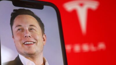 Tesla Stock Breaks Key Support After Earnings As Ai Spending Drains Cash Elon20Musk20With20The20Tesla20Logo20In20The20Background Id 2A538699 B7C6 41D5 9B5C 61Ae74D70